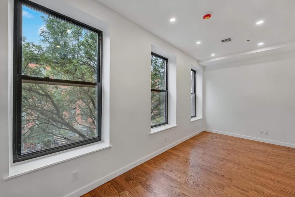 109 President Street, Unit 4 Brooklyn, NY 11231 - Photo 5 of 22 an empty room with wooden floor and a window