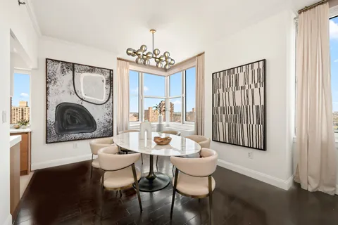 a dining room with furniture a rug and a window