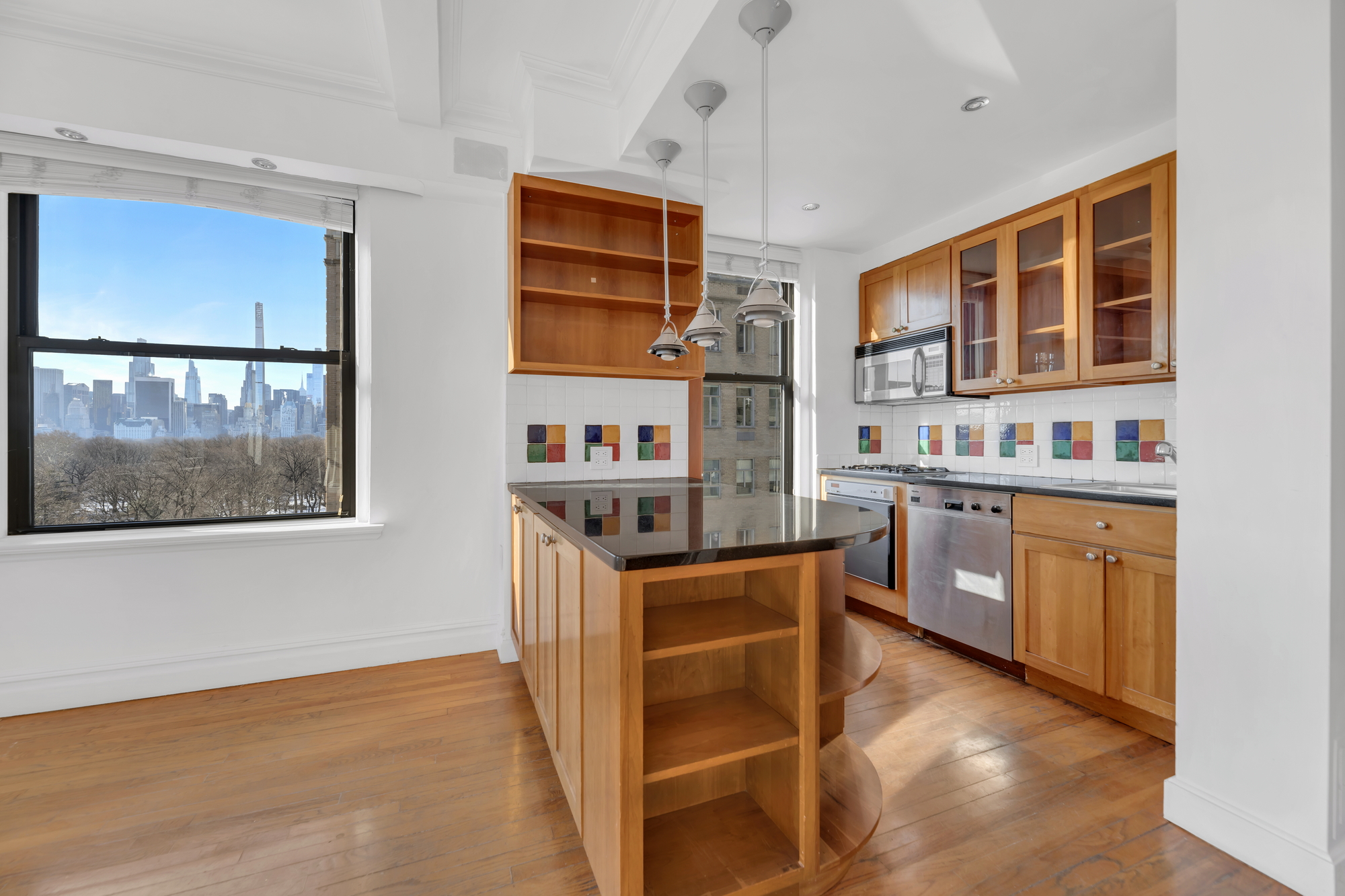 225 Central Park West, Unit 801 Manhattan, NY 10024 - Photo 8 of 21 a kitchen with stainless steel appliances granite countertop a stove and cabinets
