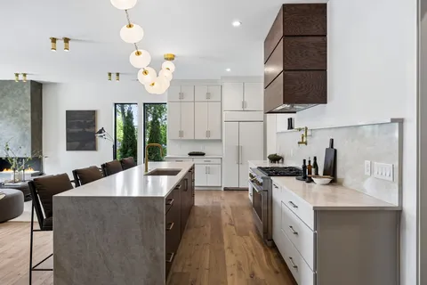 a kitchen with white cabinets and white appliances