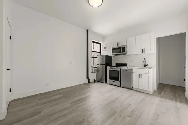 a kitchen with stainless steel appliances a refrigerator sink and microwave