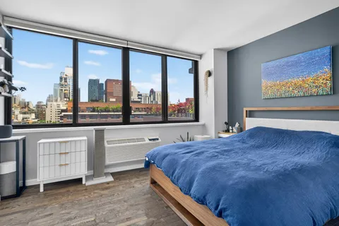 a bedroom with a large bed and a large window