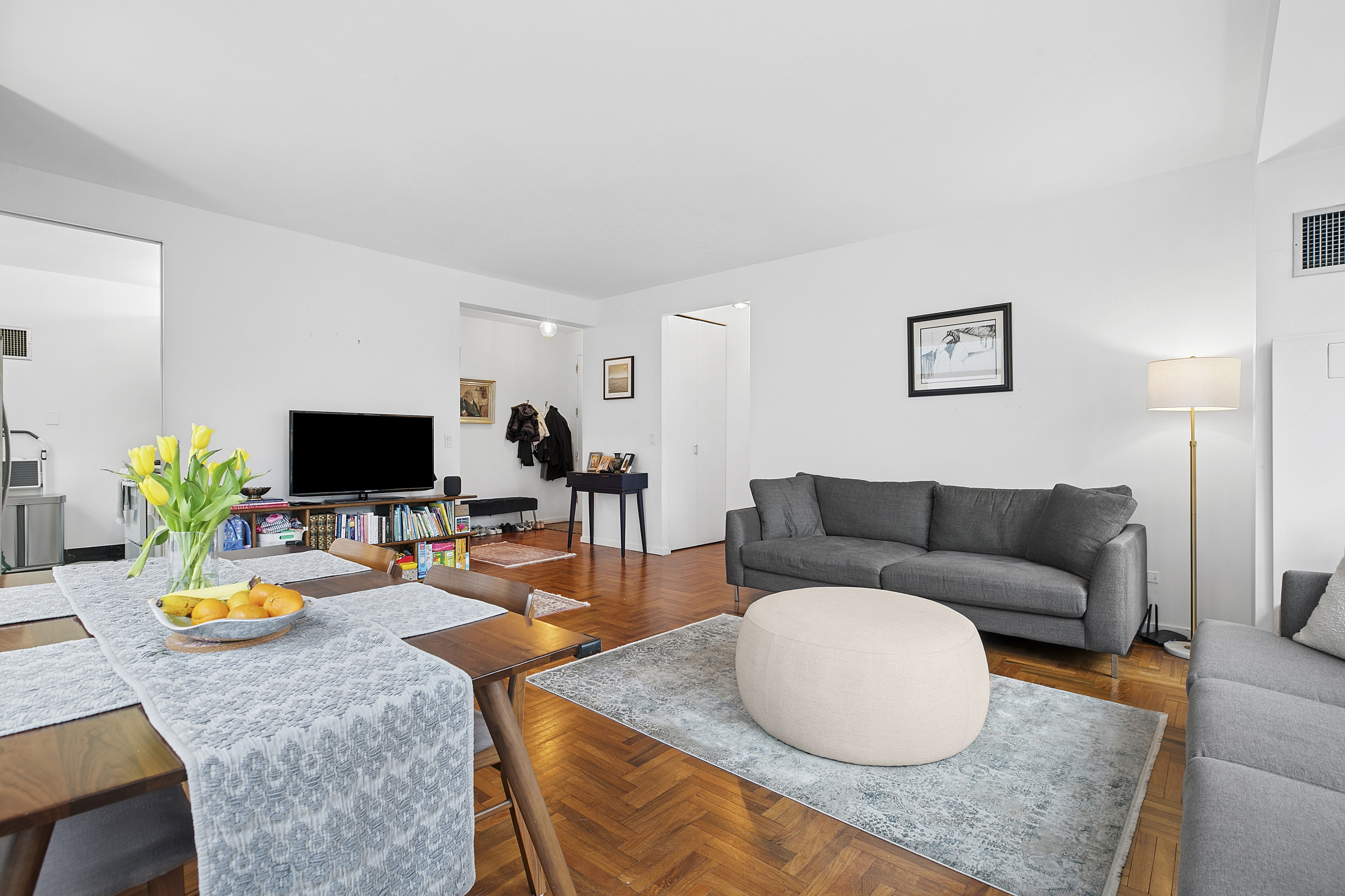 250 East 54th Street, Unit 6A Manhattan, NY 10022 - Photo 2 of 13 a living room with furniture and a flat screen tv