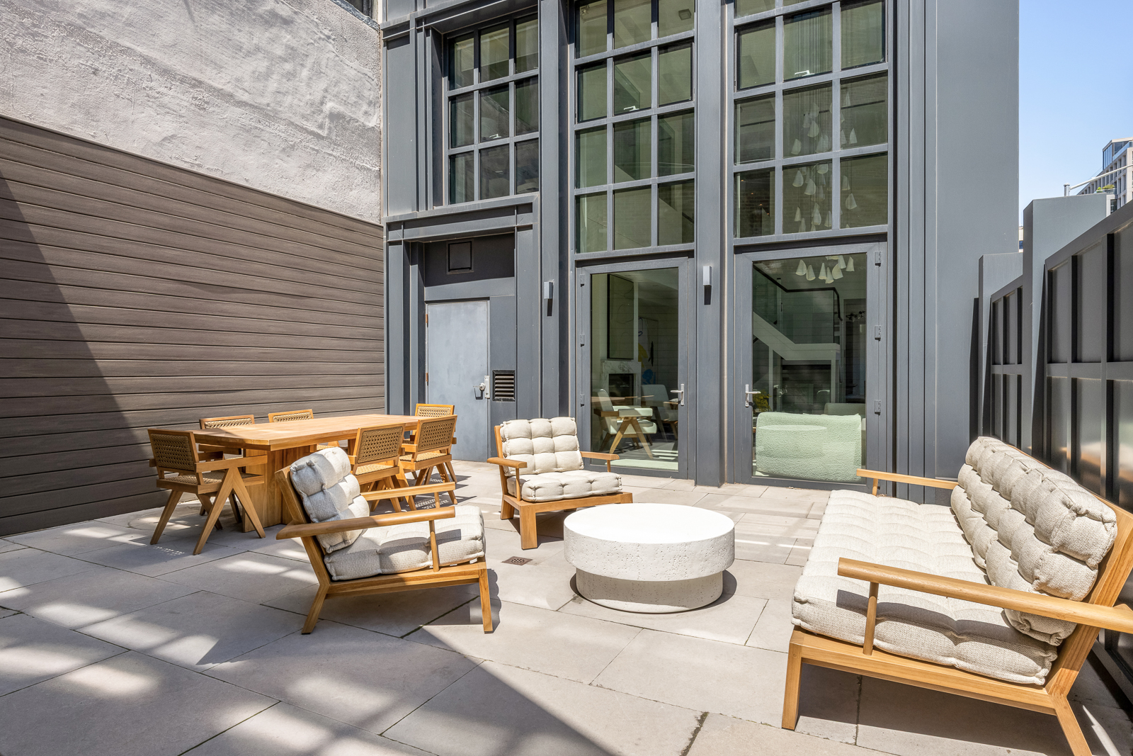 137 Franklin Street, Unit 1 Manhattan, NY 10013 - Photo 5 of 25 a outdoor space with patio the couches and a potted plant on a table