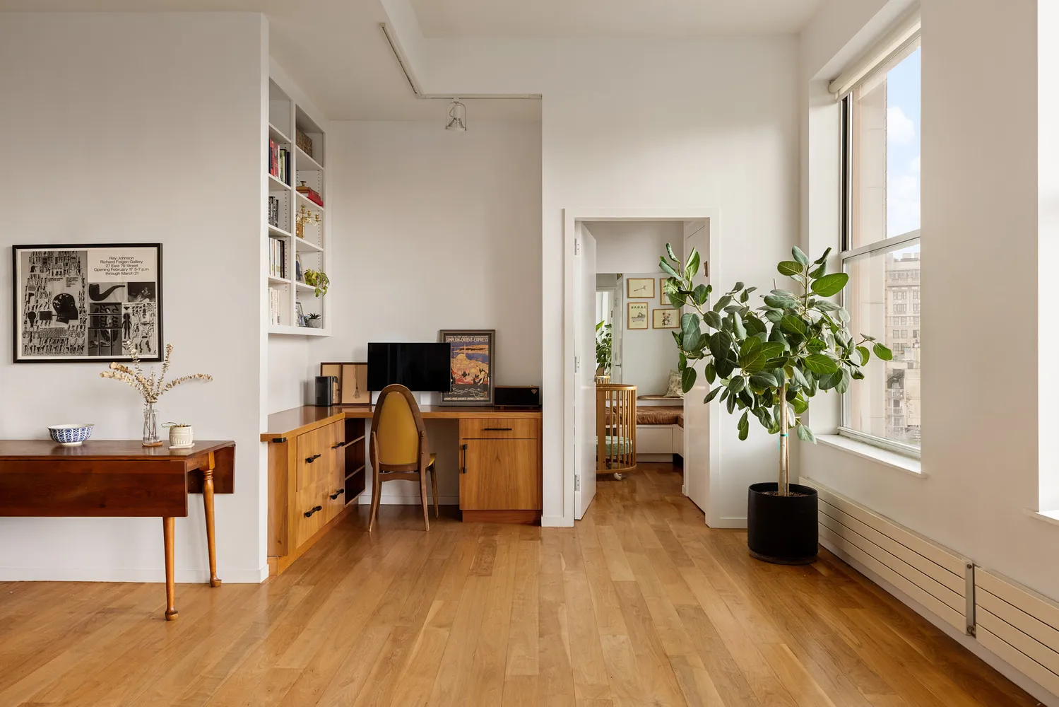 a living room with furniture and a potted plant