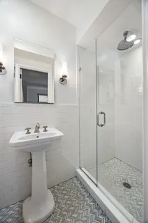 a bathroom with a sink toilet and shower