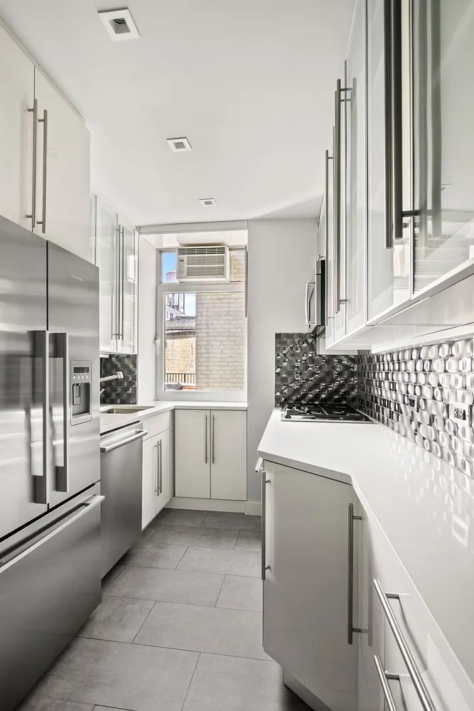 a kitchen that has a sink and a stove in it