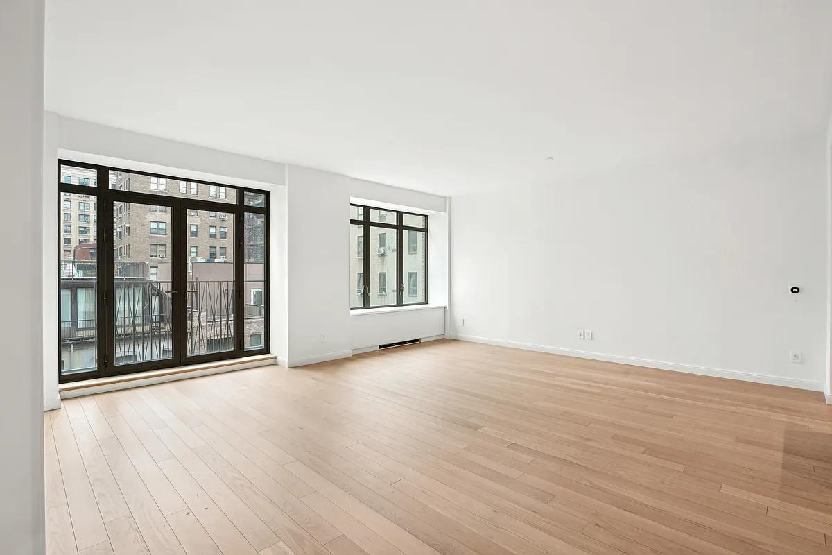 269 West 87th Street, Unit 7B Manhattan, NY 10024 - Photo 1 of 21 an empty room with wooden floor and windows