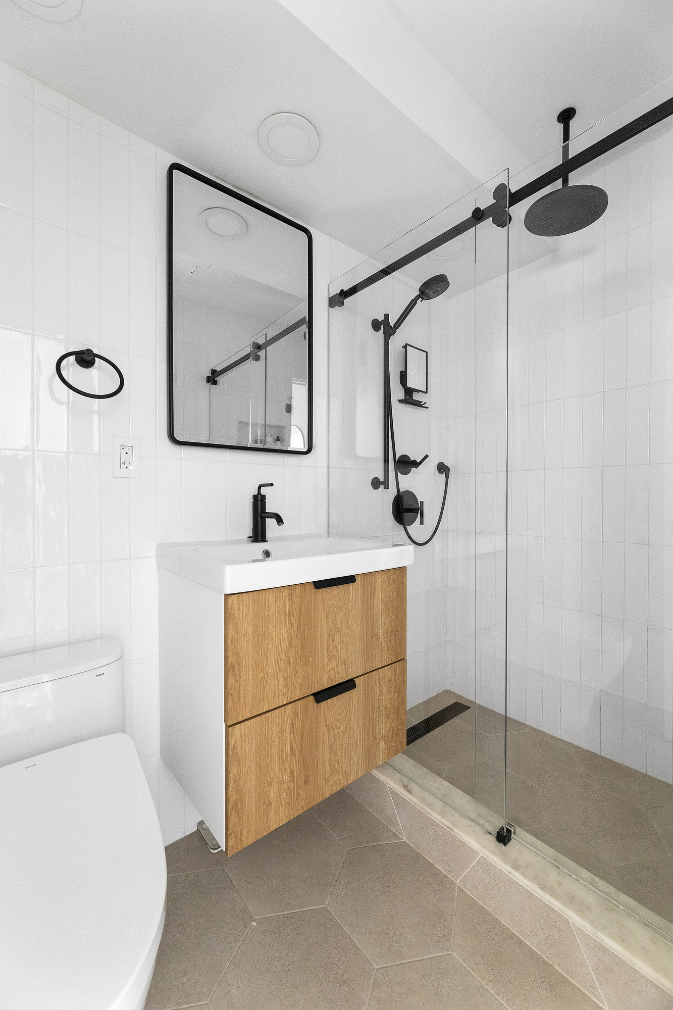 145 East 15th Street, Unit 2T Manhattan, NY 10003 - Photo 5 of 10 a bathroom with a sink a vanity and a mirror