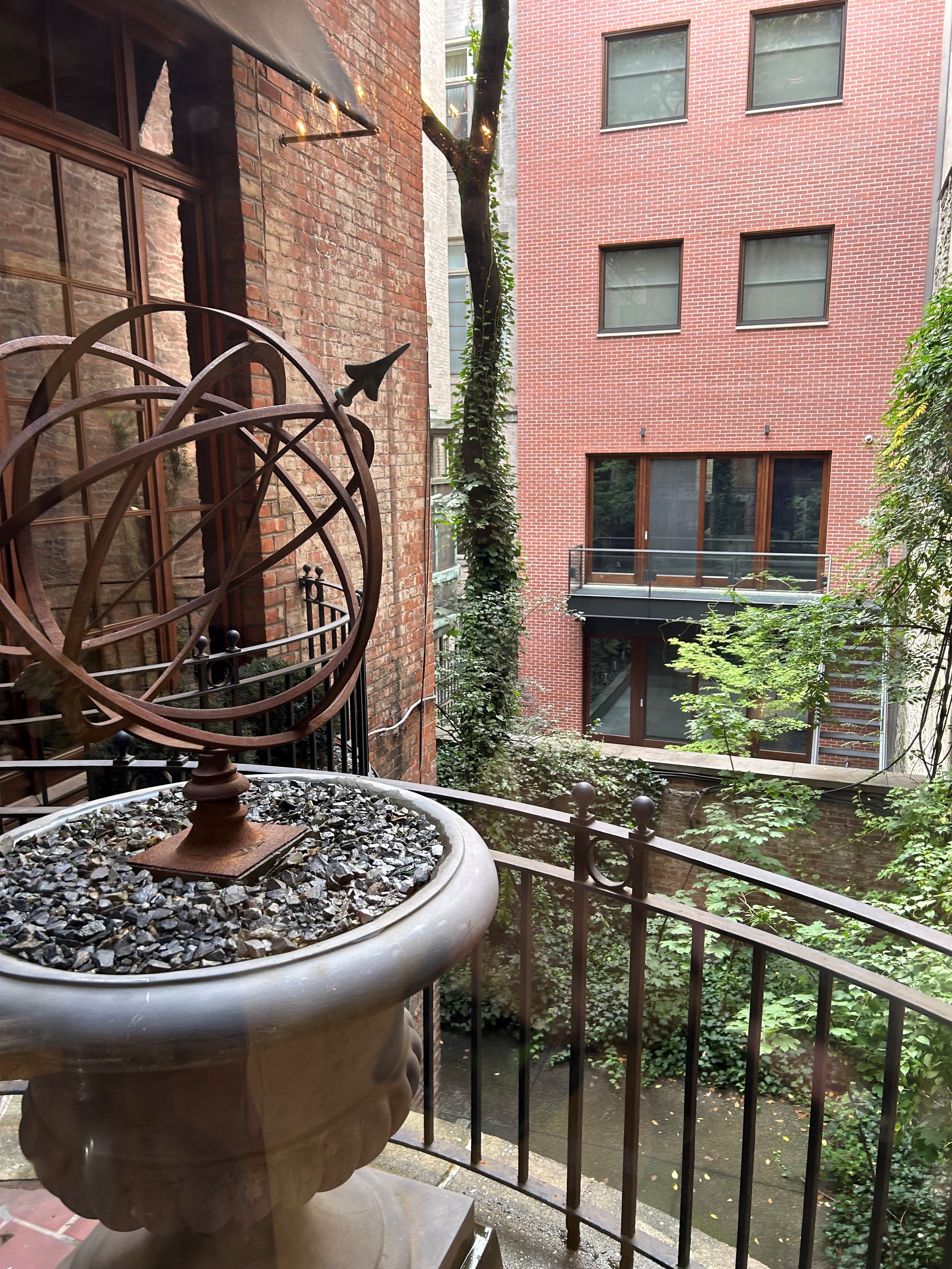 36 East 69th Street, Unit 2AB Manhattan, NY 10021 - Photo 19 of 26 a table and chairs in front of a house