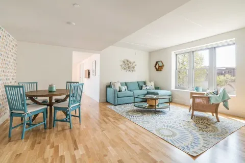 a living room with furniture and a wooden floor