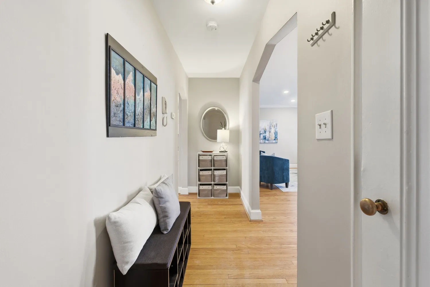 a living room with furniture and a mirror