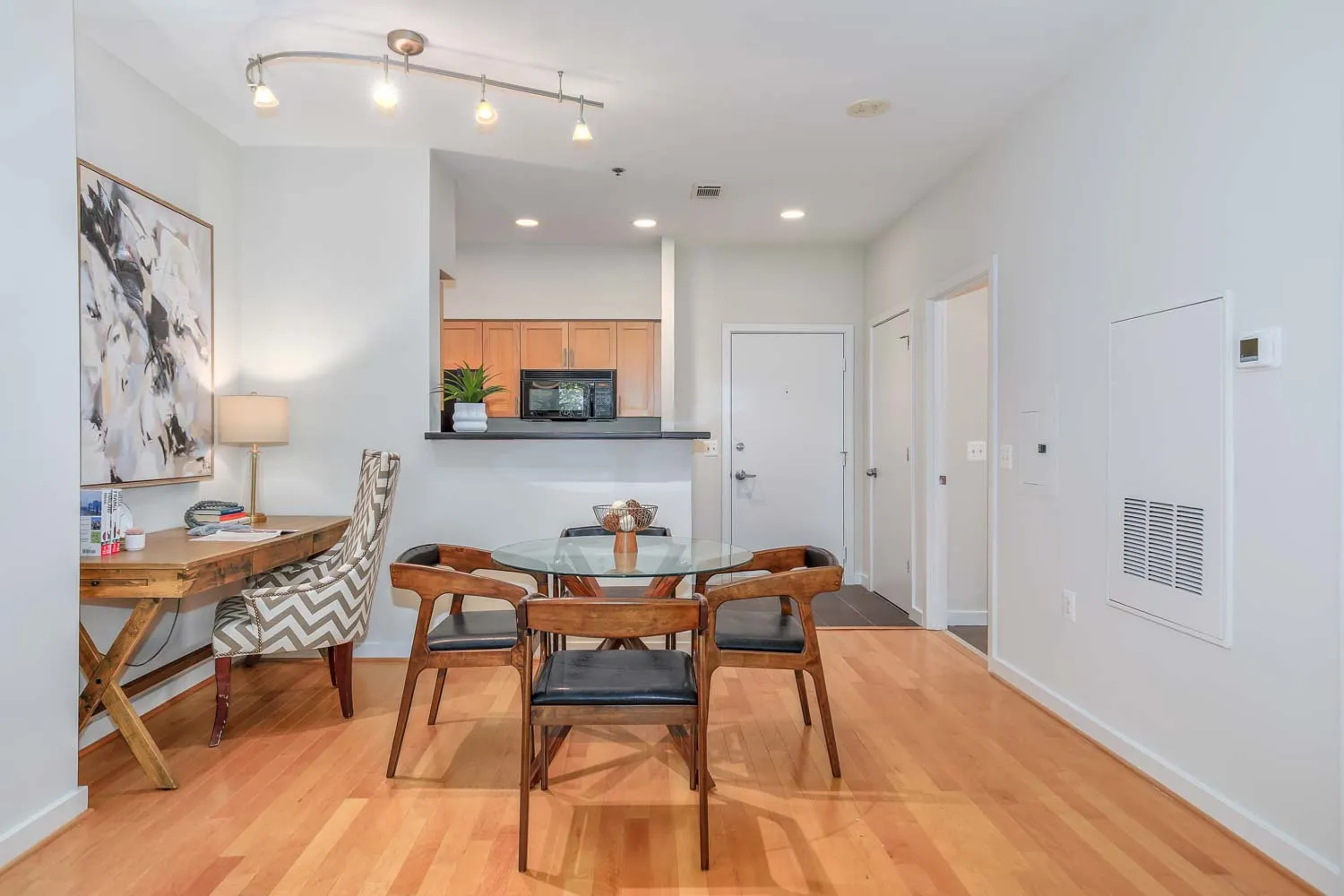 a view of a dining room with furniture and wooden floor