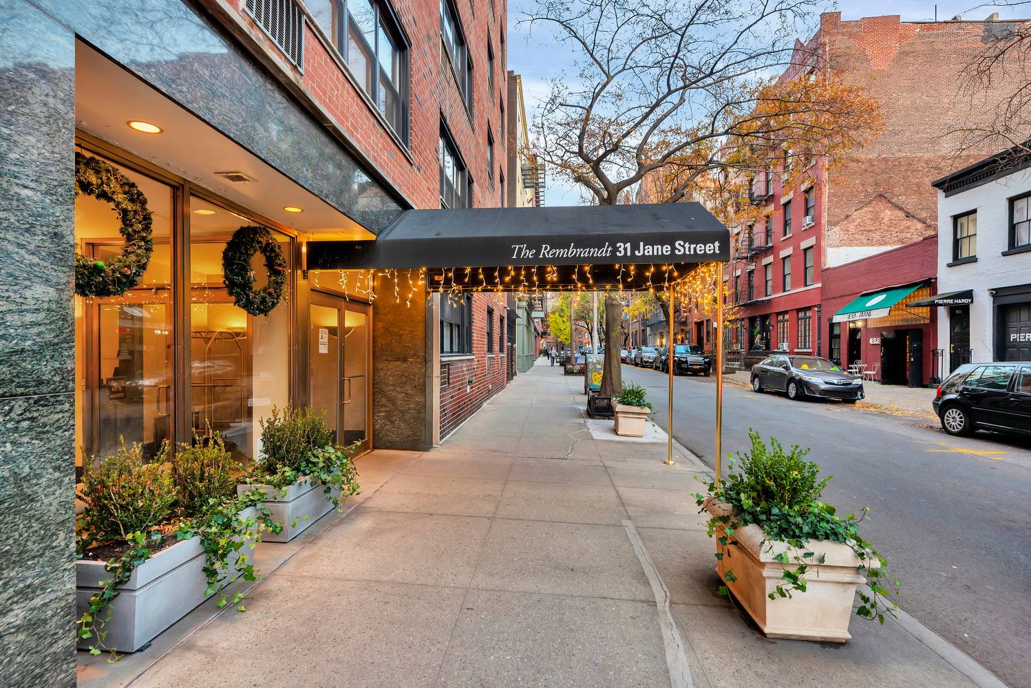 31 Jane Street, Unit 16A Manhattan, NY 10014 - Photo 16 of 17 a building with potted plants in front of it