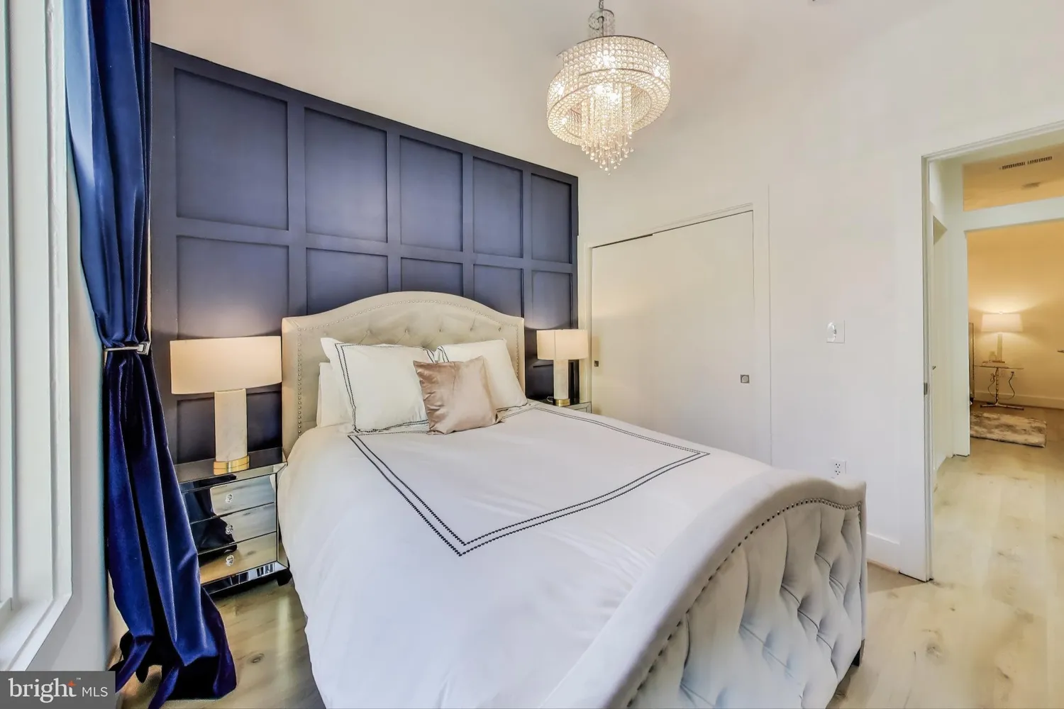 a bedroom with a bed and a chandelier