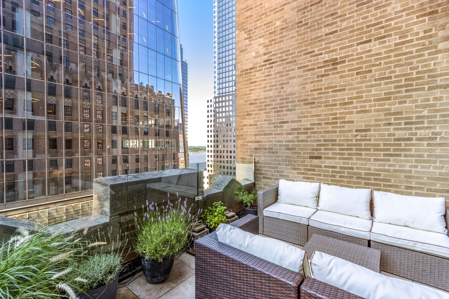 100 Barclay Street, Unit 14M Manhattan, NY 10007 - Photo 7 of 19 a view of a patio with couches and potted plants