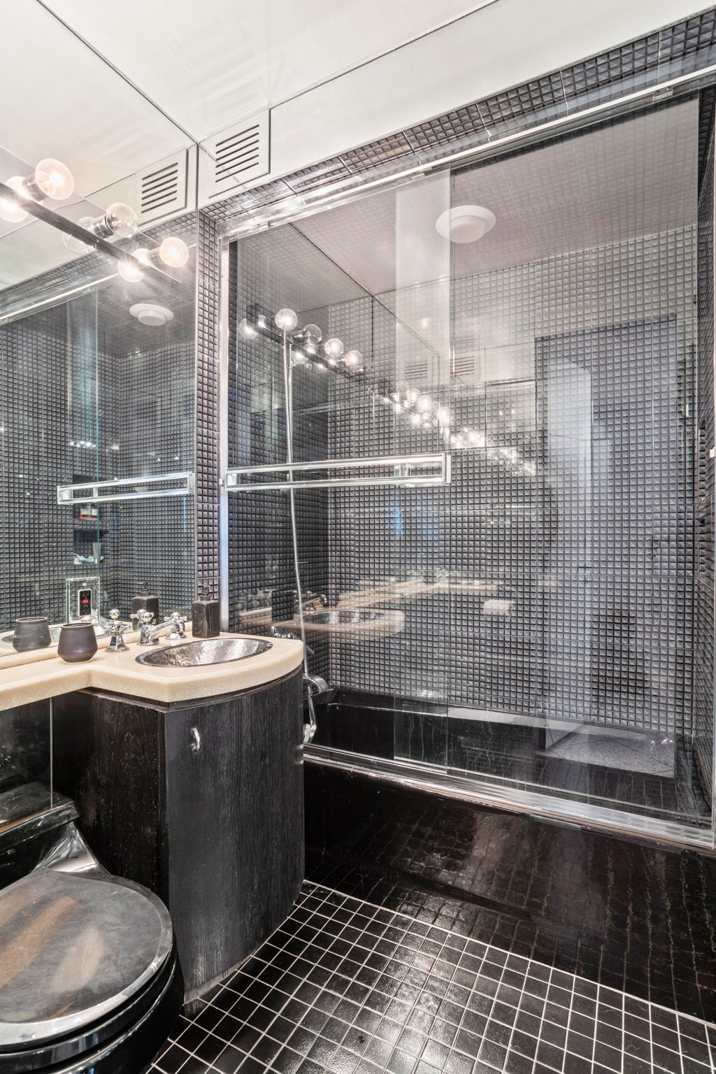 363 East 76th Street, Unit 2F Manhattan, NY 10075 - Photo 14 of 21 a room with a wooden floor and a glass door shower