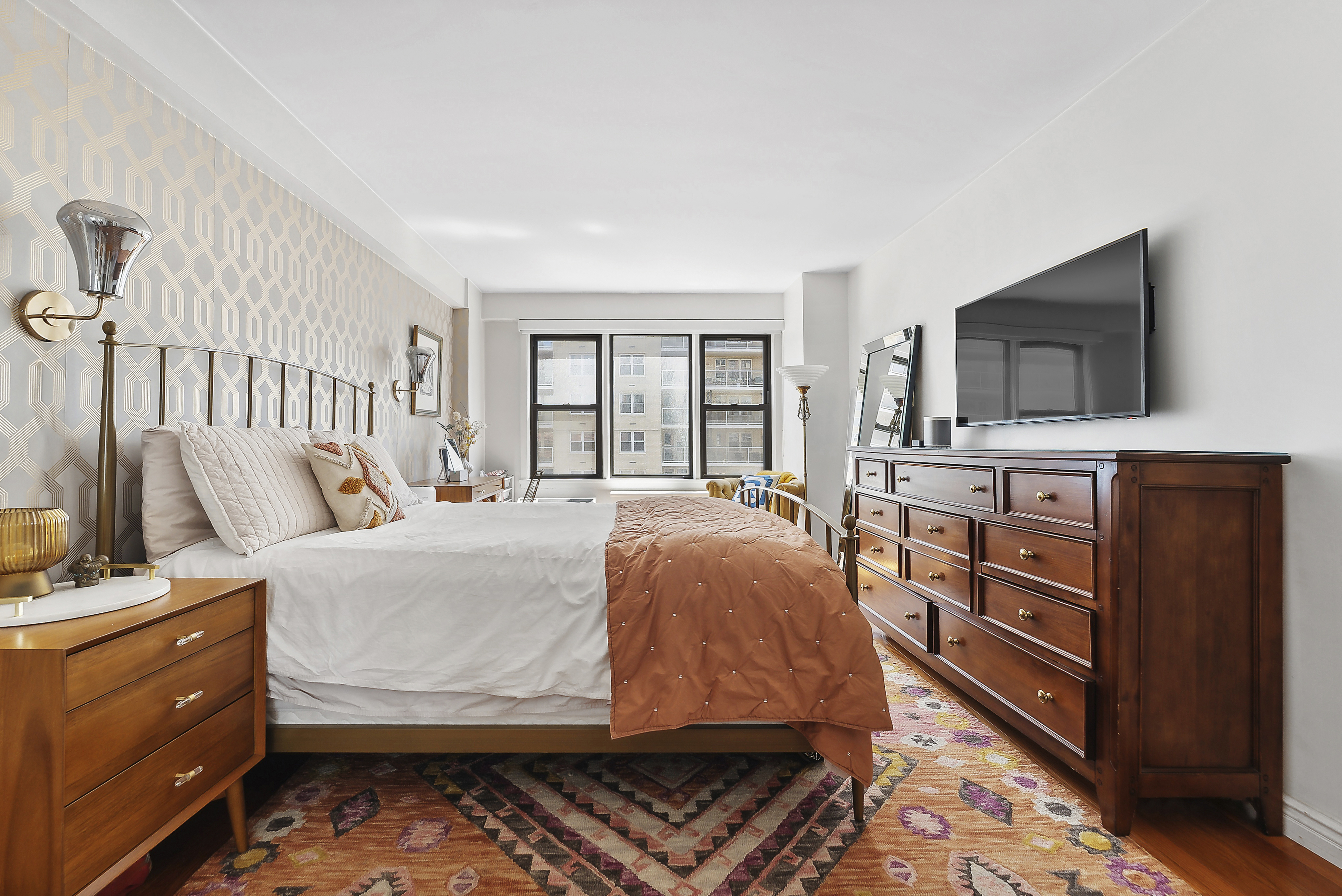 245 East 24th Street, Unit 10D Manhattan, NY 10010 - Photo 4 of 6 a bedroom with a bed and flat screen tv