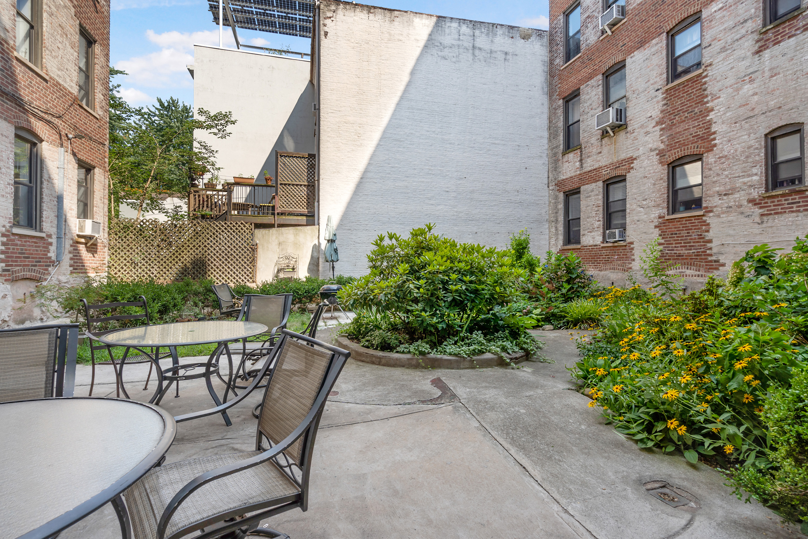 425 Prospect Place, Unit 1J Brooklyn, NY 11238 - Photo 11 of 11 a view of a patio with table and chairs and potted plants