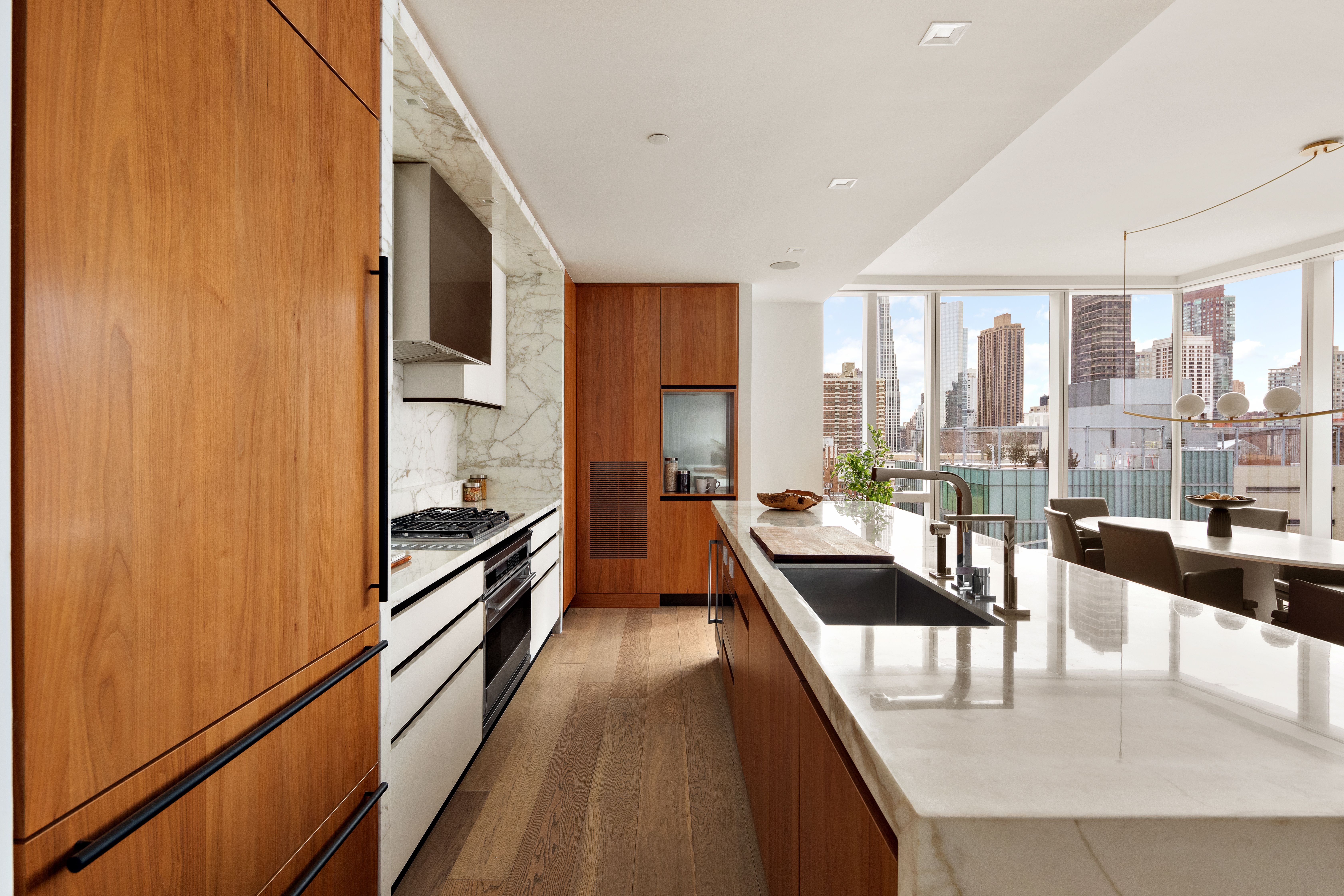 1 West End Avenue, Unit 12D Manhattan, NY 10023 - Photo 4 of 32 a dining hall with stainless steel appliances granite countertop a stove and a refrigerator