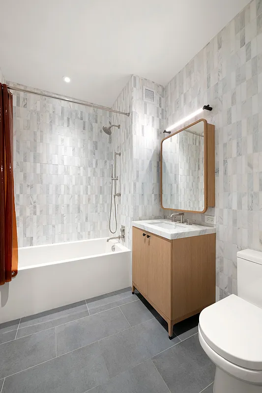 180 Front Street, Unit 7B Brooklyn, NY 11201 - Photo 9 of 25 a bathroom with a sink a mirror a toilet and bathtub