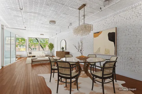 a dining room with furniture and wooden floor