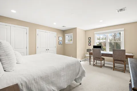 a spacious bedroom with a bed and a table in it