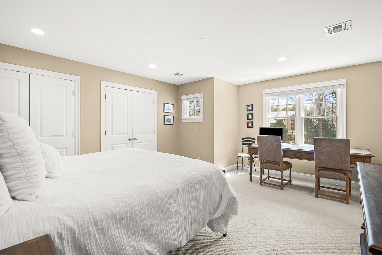 Country Way Needham, MA 02492 - Photo 19 of 27 a spacious bedroom with a bed and a table in it