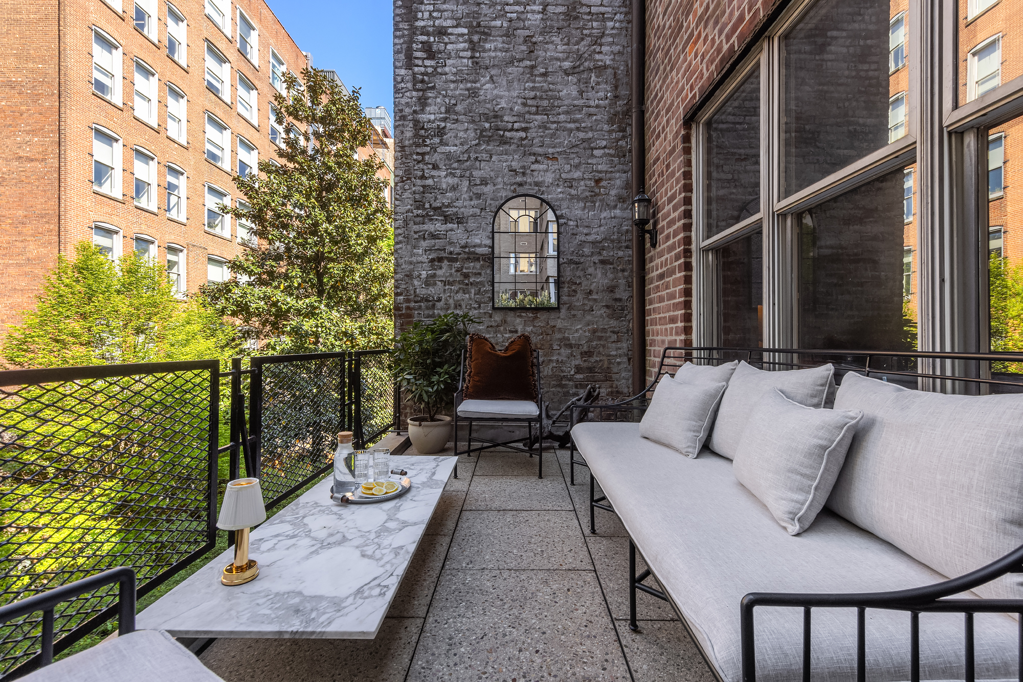159 West 13th Street Manhattan, NY 10011 - Photo 27 of 36 a balcony with couch and wooden floor