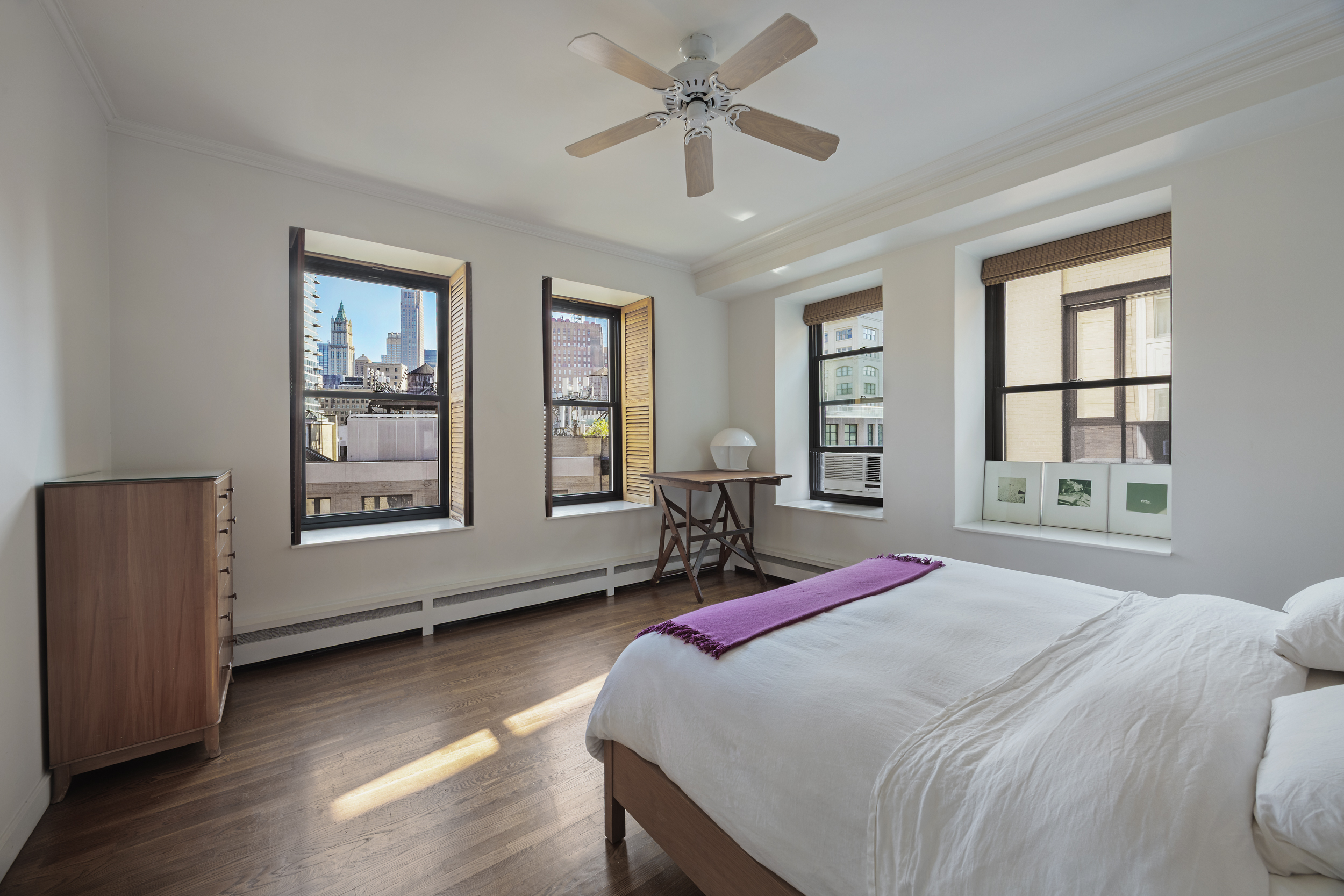 260 West Broadway, Unit 10D Manhattan, NY 10013 - Photo 8 of 20 a bedroom with a bed a dresser and windows