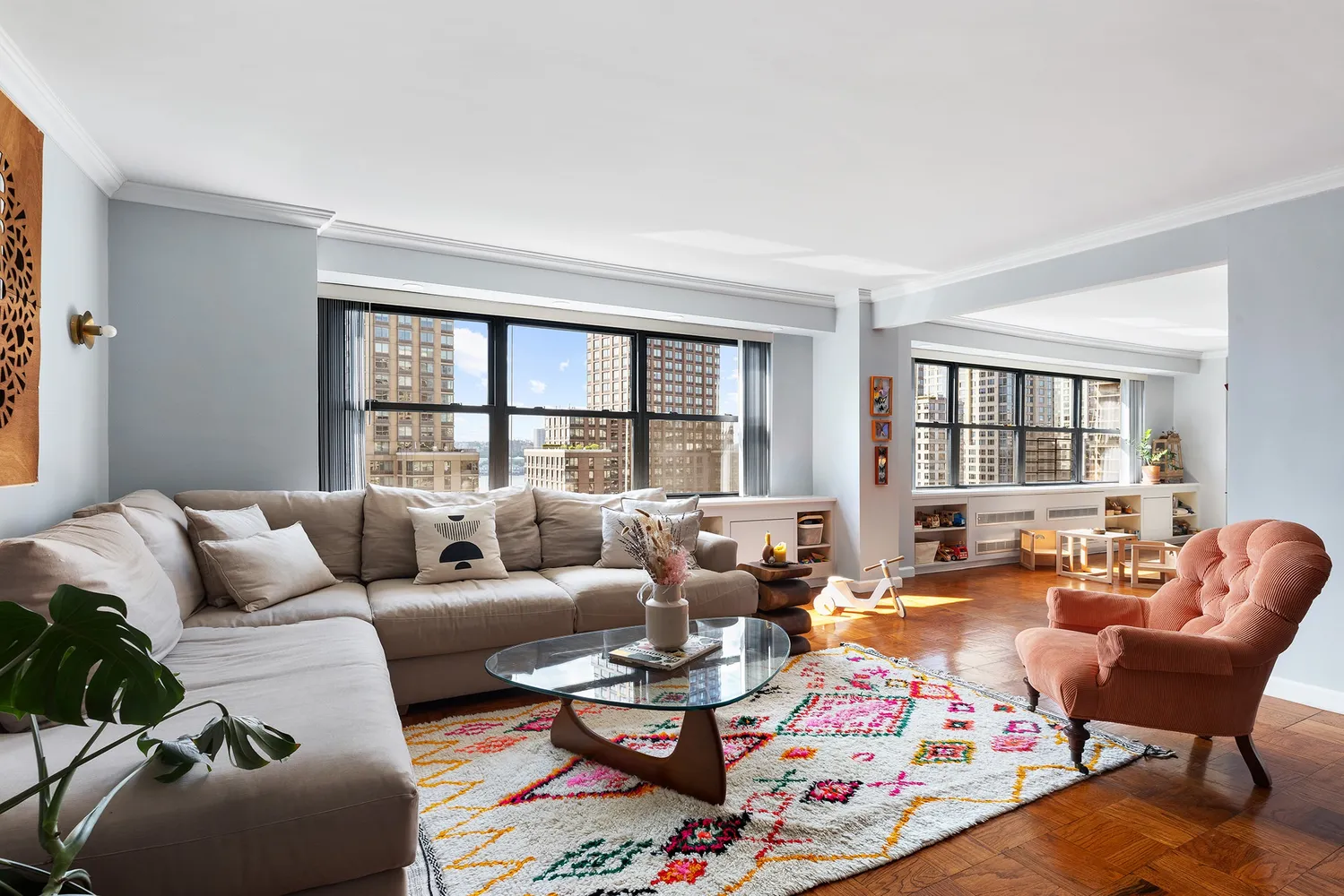 a living room with furniture and a floor to ceiling window