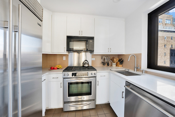 100 United Nations Plaza, Unit 8A Manhattan, NY 10017 - Photo 5 of 12 a kitchen with a stove top oven and sink