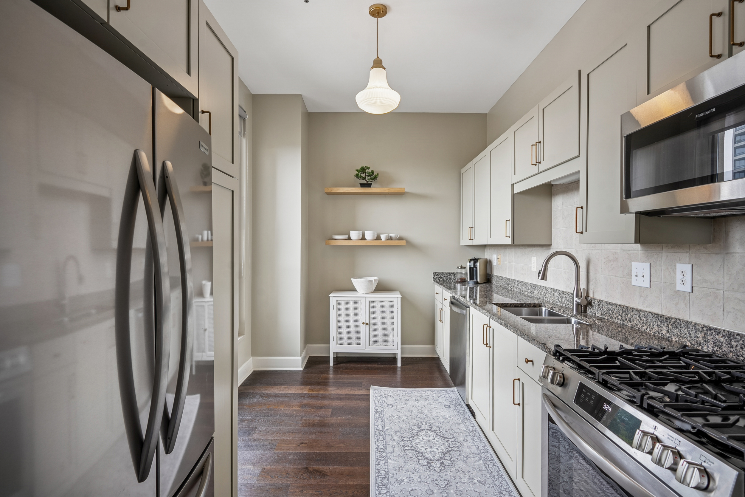 2626 Peachtree Road, Unit 1108 Atlanta, GA 30305 - Photo 8 of 25 a kitchen with stainless steel appliances granite countertop a refrigerator stove and sink