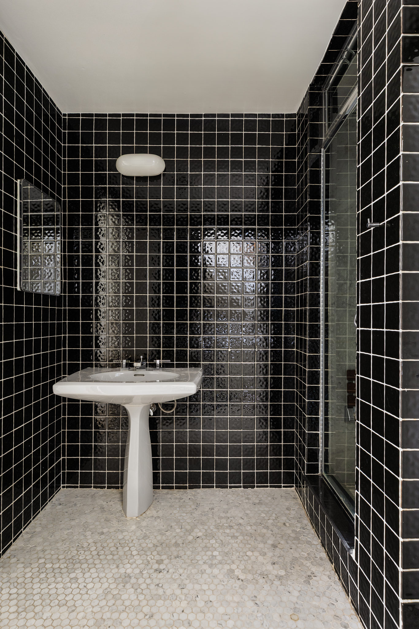 348 West 20th Street Manhattan, NY 10011 - Photo 13 of 18 a bathroom with a sink toilet and blue shower
