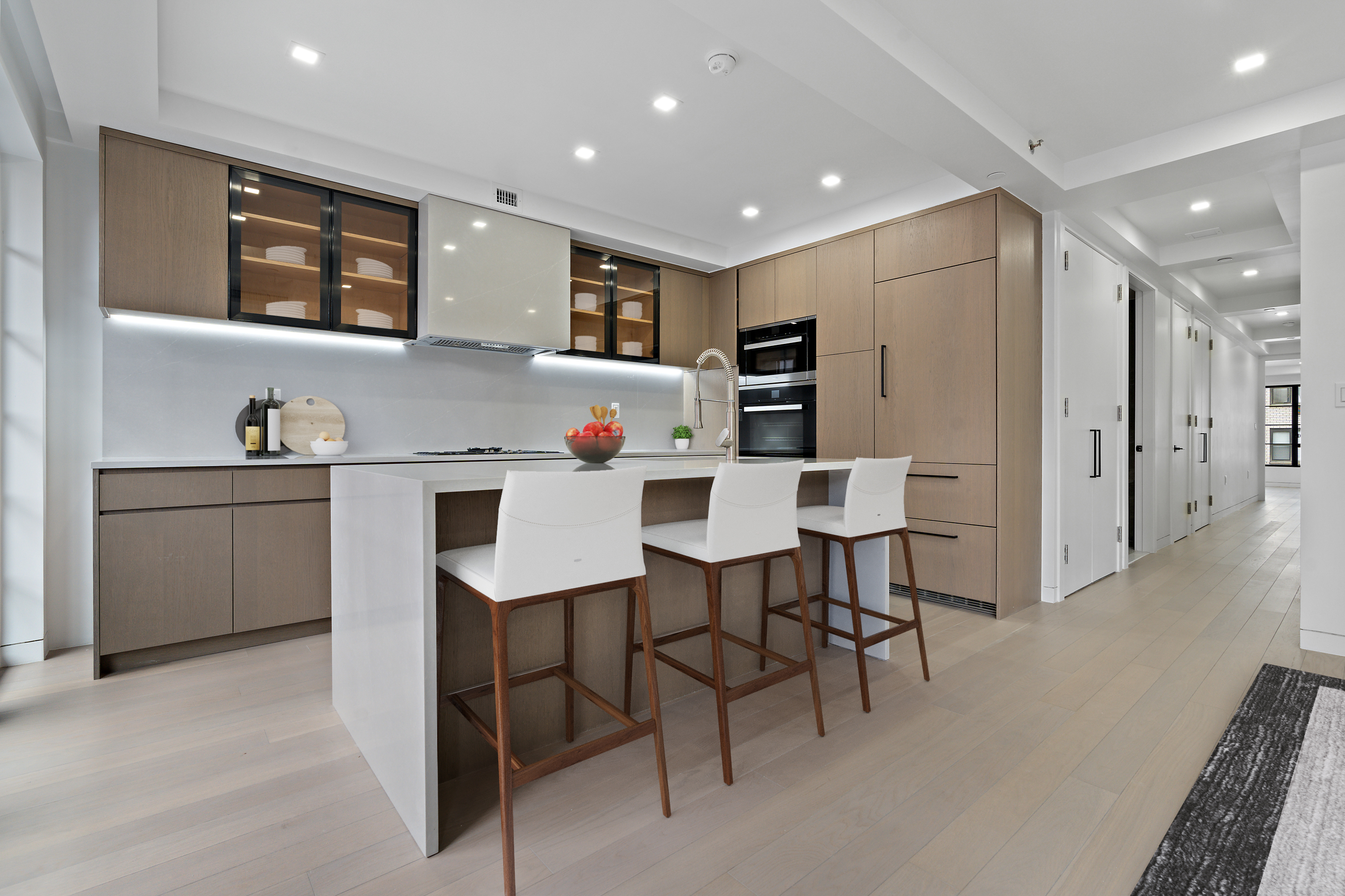 327 East 22nd Street, Unit 3A Manhattan, NY 10010 - Photo 6 of 14 a kitchen with stainless steel appliances kitchen island granite countertop a dining table chairs and sink