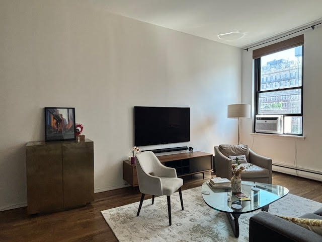 250 Mercer Street, Unit D603 Manhattan, NY 10012 - Photo 14 of 20 a livingroom with workspace and a couch