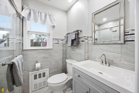 a bathroom with a toilet sink and mirror