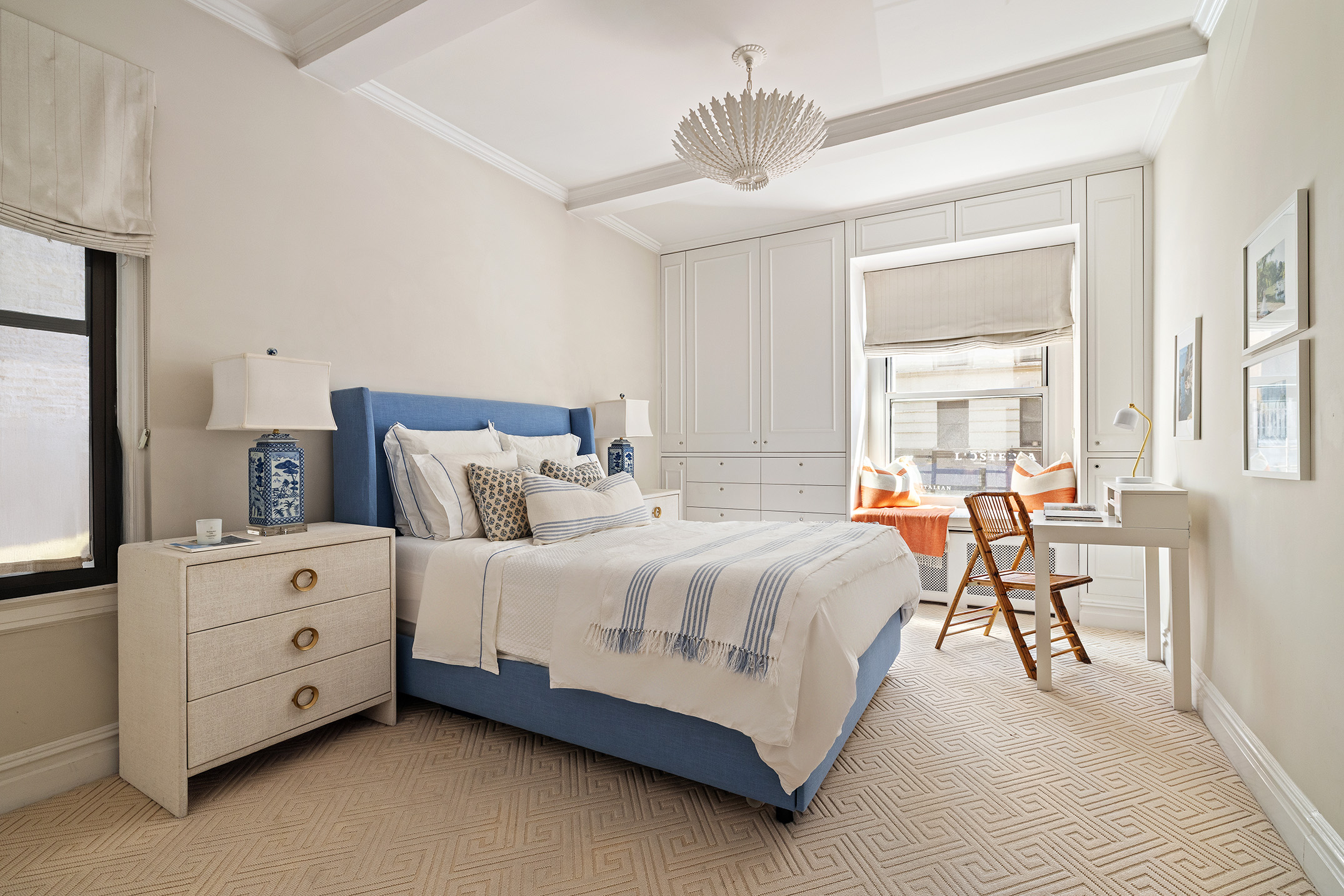129 East 82nd Street, Unit 1C Manhattan, NY 10028 - Photo 6 of 13 a spacious bedroom with a bed and a chandelier