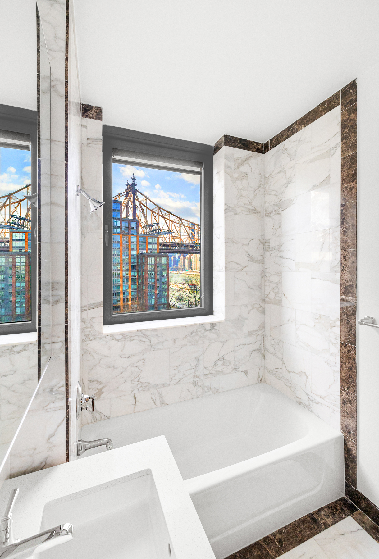 425 Main Street, Unit 9F Manhattan, NY 10044 - Photo 6 of 15 a bathroom with a bathtub and a shower