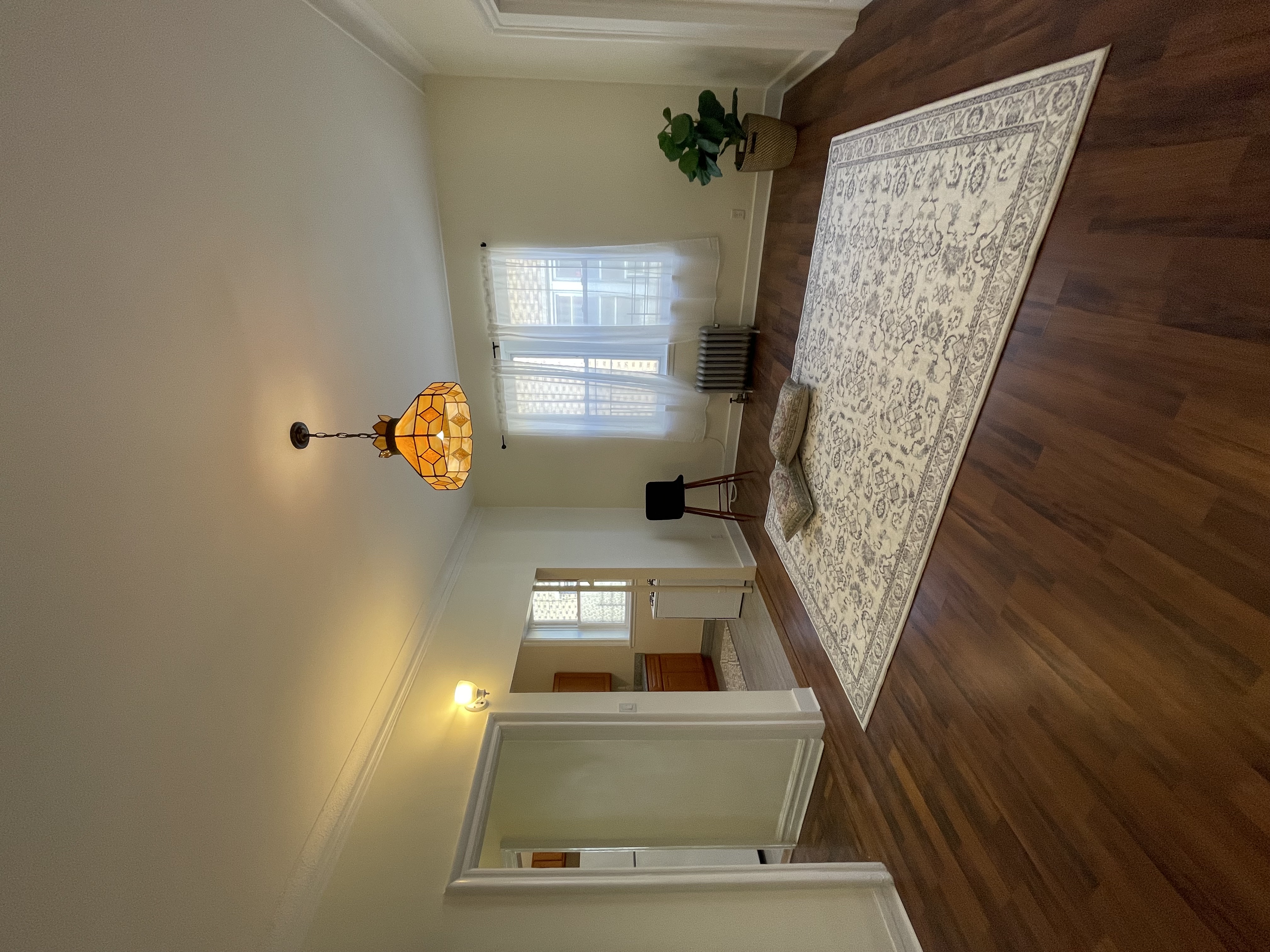 a view of a livingroom with wooden floor and window