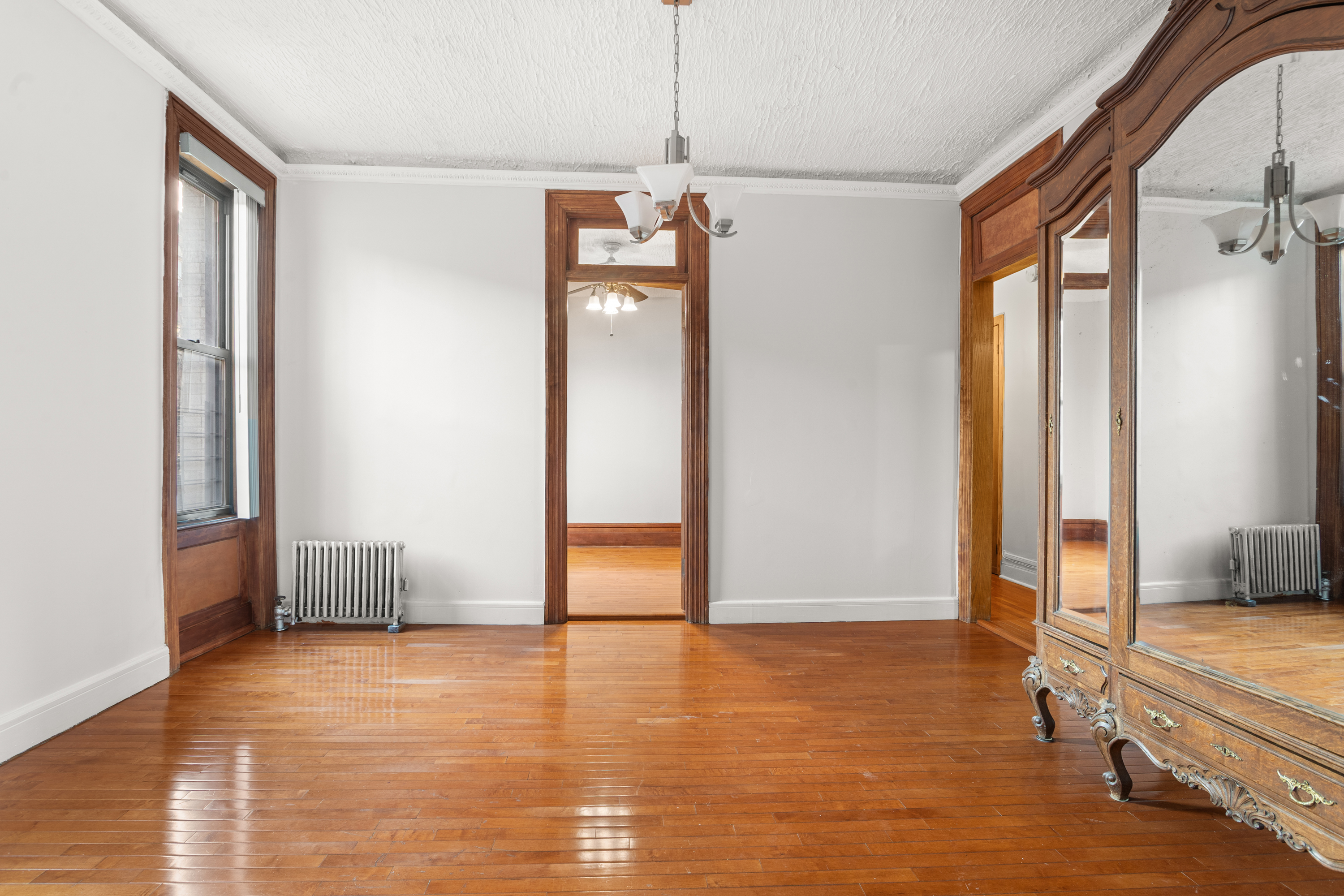 527 West 143rd Street, Unit 31 Manhattan, NY 10031 - Photo 6 of 29 a view of a room with wooden floor and windows