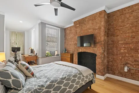 a bedroom with a bed and a fireplace