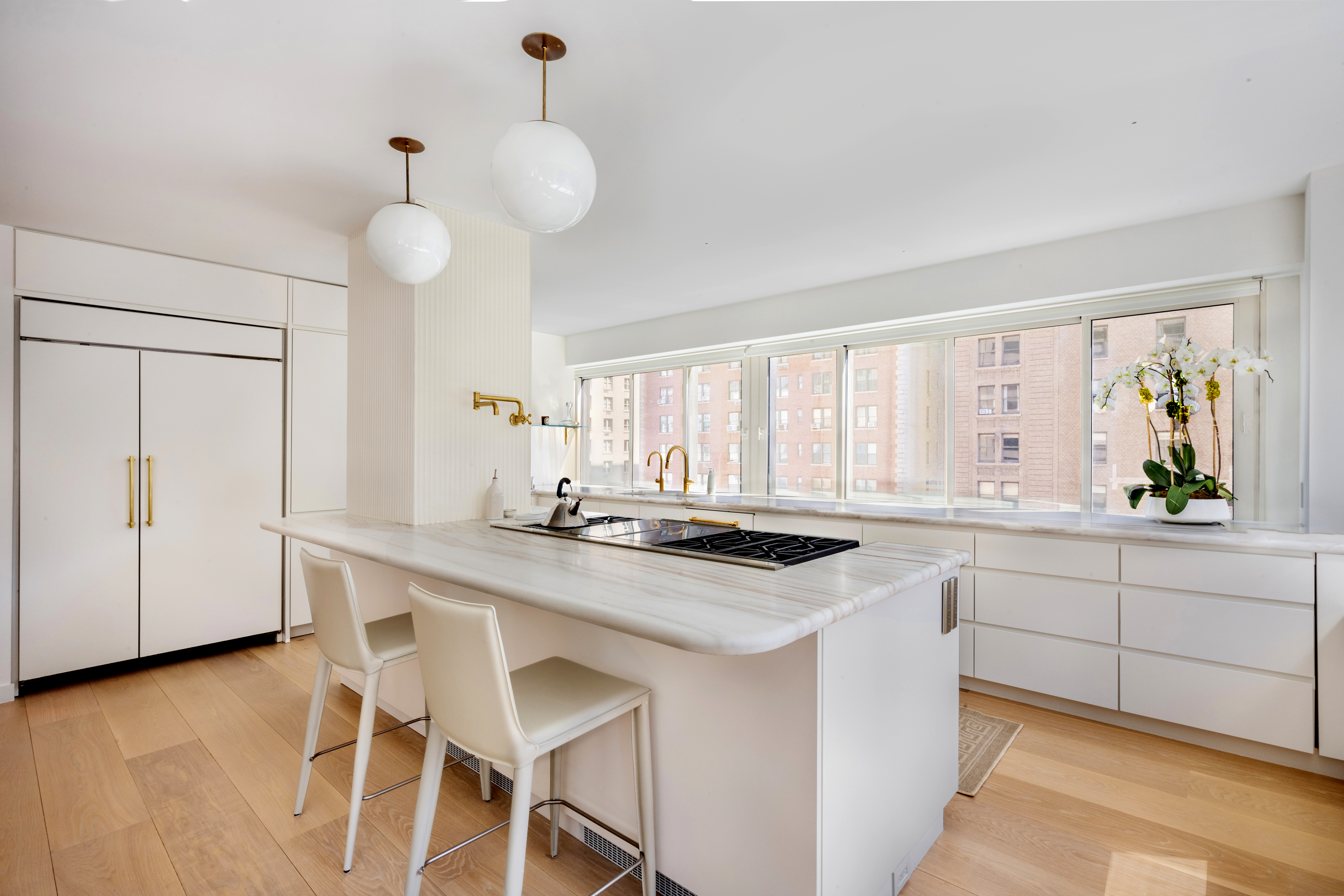 900 Park Avenue, Unit 7ABCE Manhattan, NY 10075 - Photo 7 of 18 a kitchen with a table chairs stove and cabinets