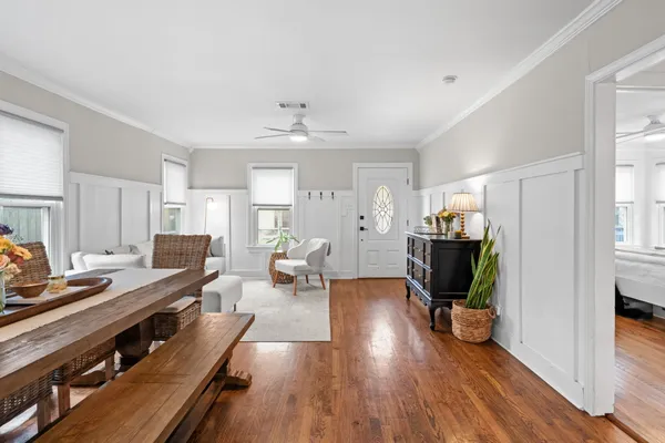 a living room with furniture a wooden floor and a fireplace