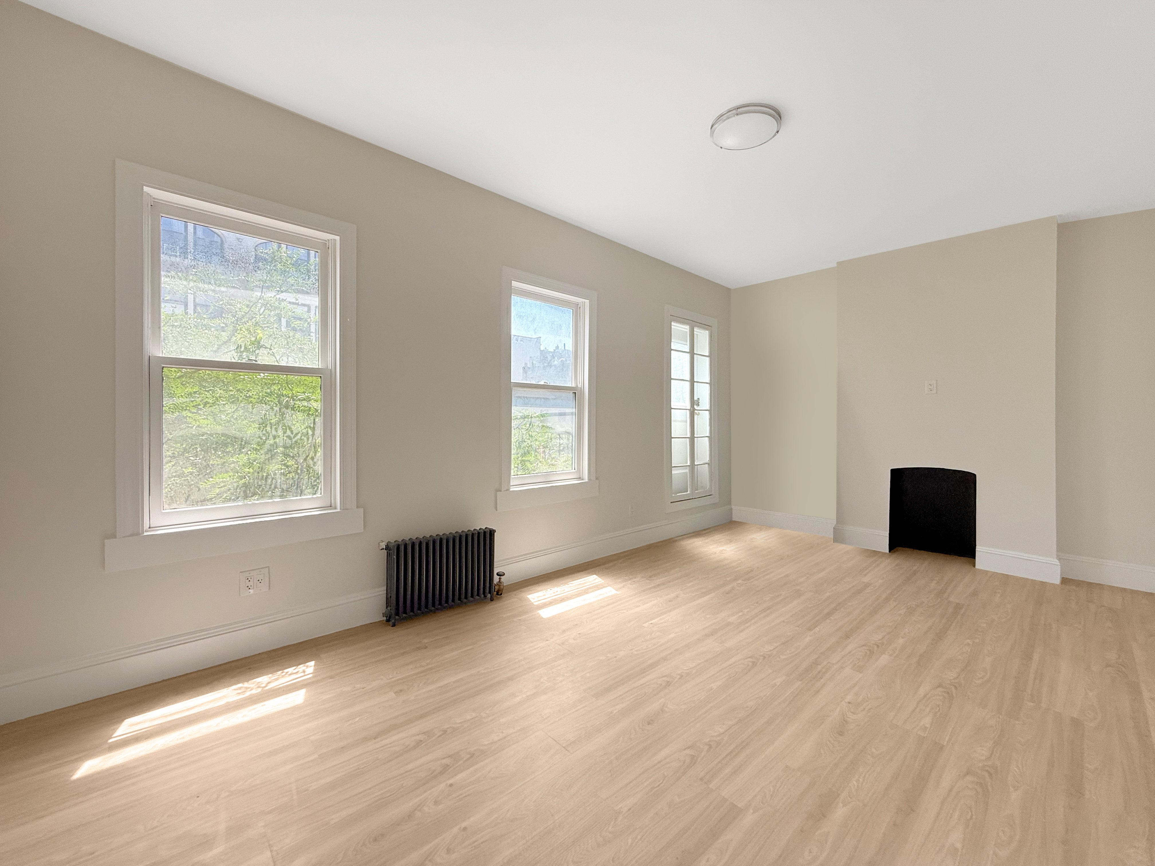 461 6th Avenue, Unit 3 Manhattan, NY 10011 - Photo 2 of 6 a view of an empty room with window and wooden floor