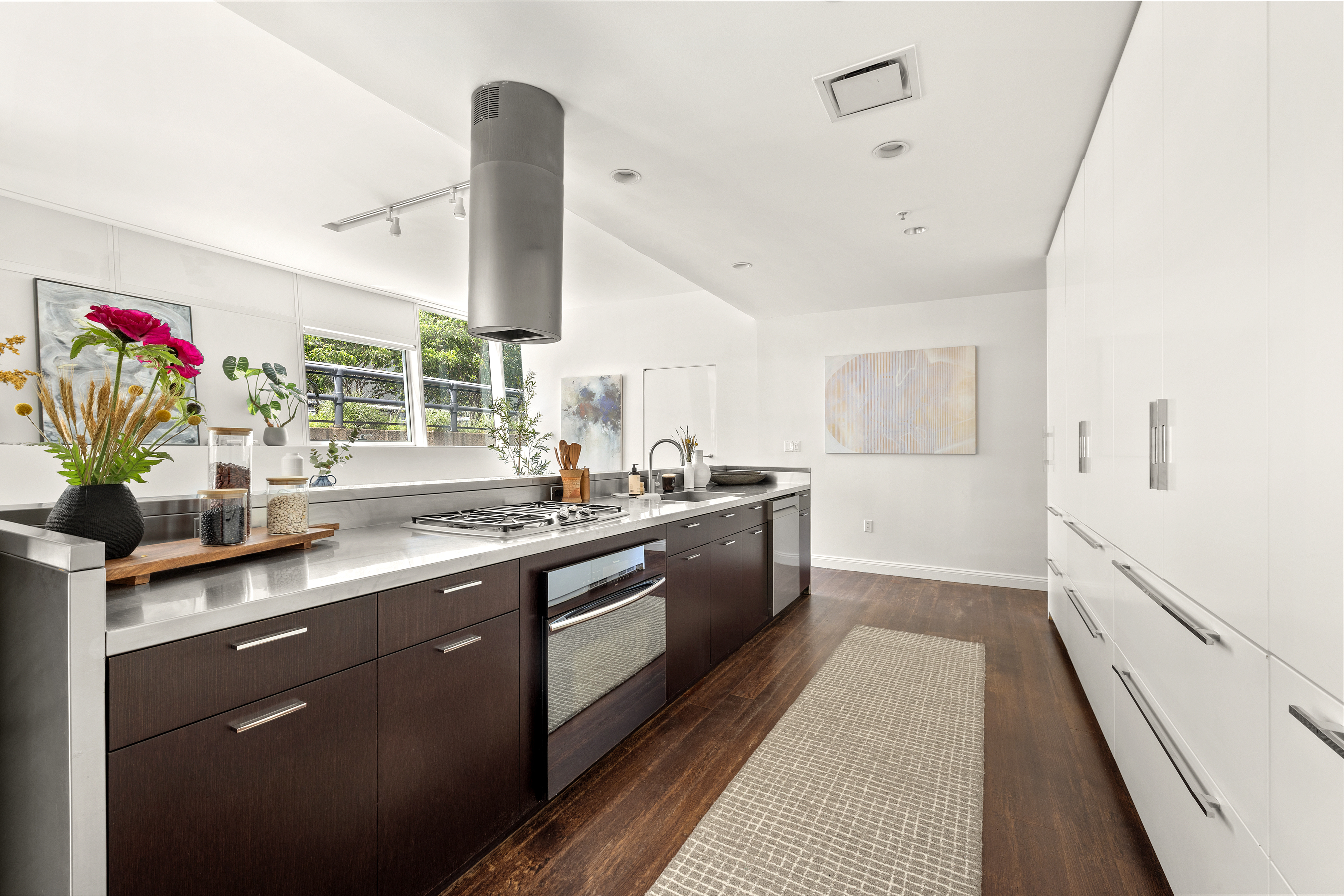 245 10th Avenue, Unit 2W Manhattan, NY 10001 - Photo 5 of 16 a kitchen with stainless steel appliances granite countertop a sink a stove and a wooden floors