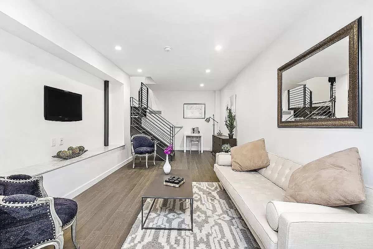 44 East End Avenue, Unit TH1 Manhattan, NY 10028 - Photo 3 of 14 a living room with furniture and a flat screen tv