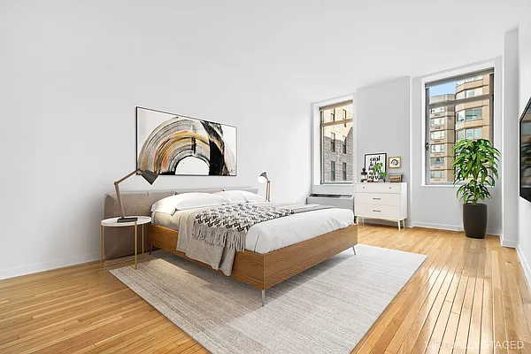 252 7th Avenue, Unit 10I Manhattan, NY 10001 - Photo 6 of 25 a bedroom with a large bed and a window