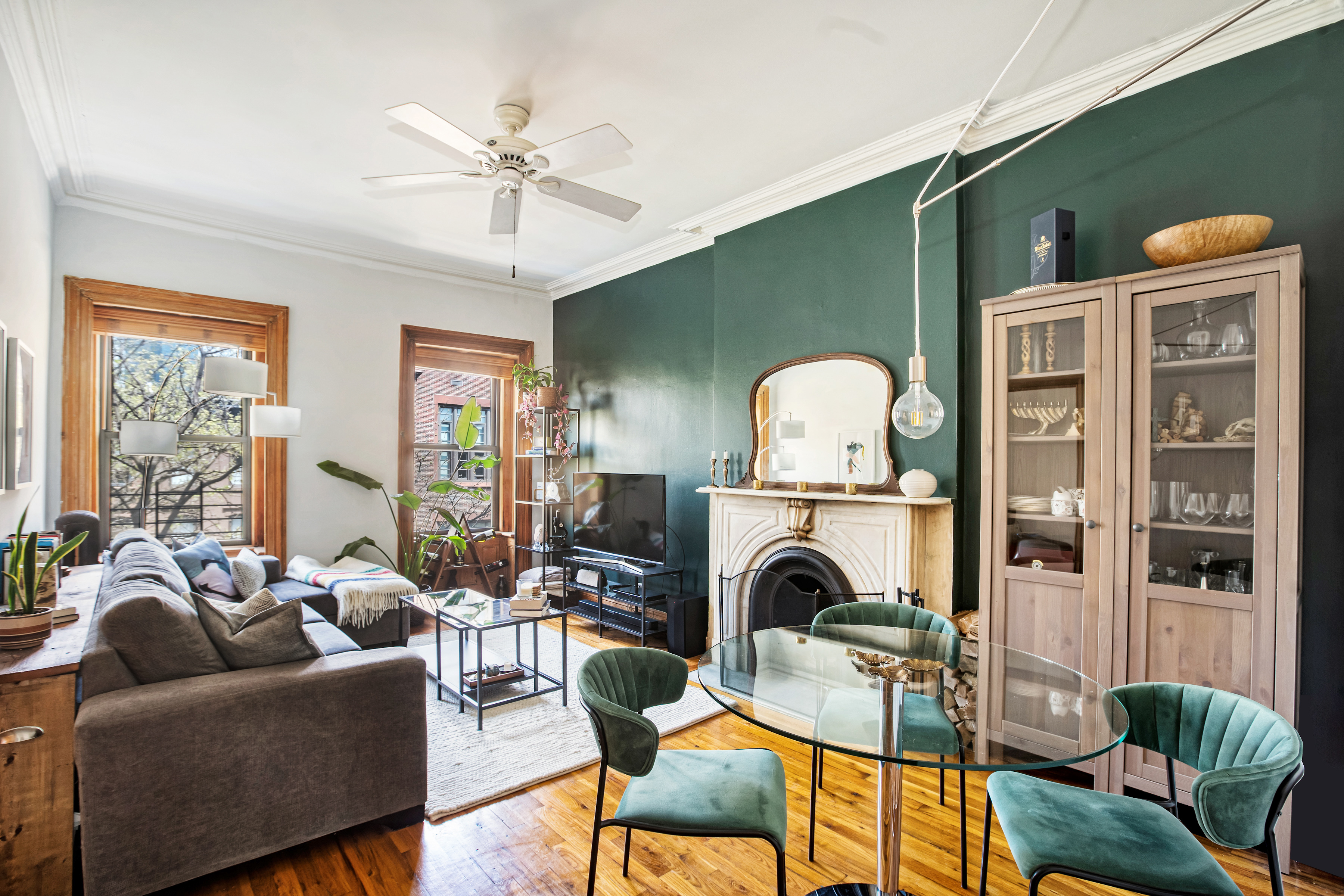 a living room with furniture a fireplace and large windows