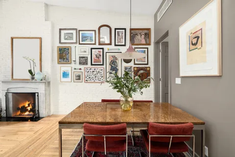 a dining room with furniture and wooden floor
